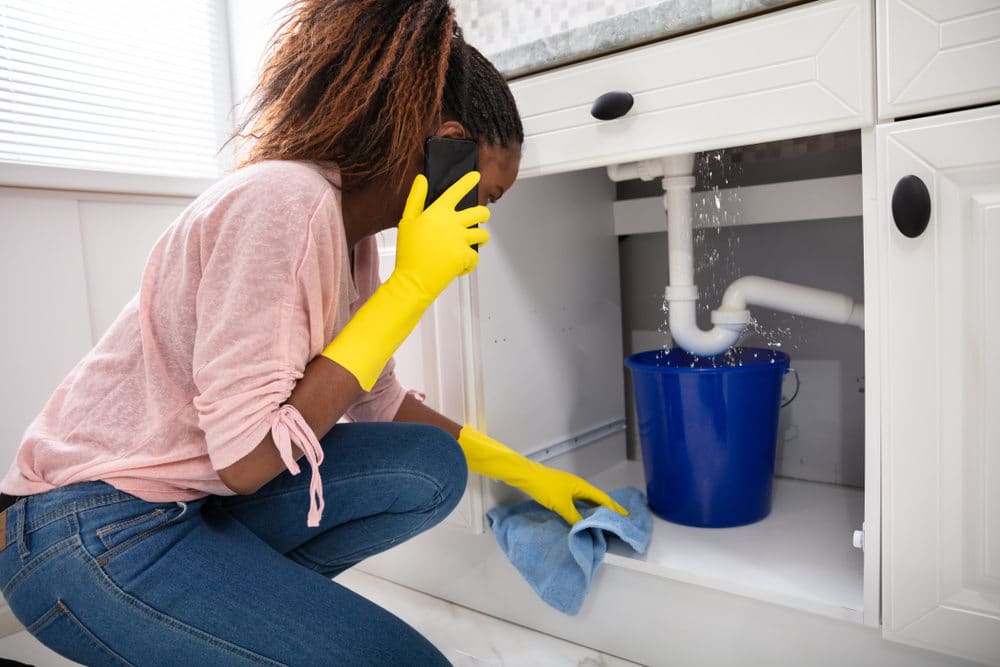 Close-up,Of,A,Young,Woman,Placing,Blue,Bucket,Under,Water
